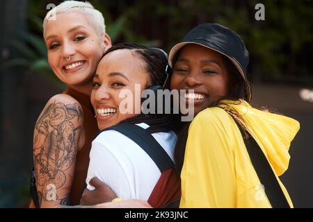 If you have good friends, you have everything. three close friends spending the day together in the city. Stock Photo