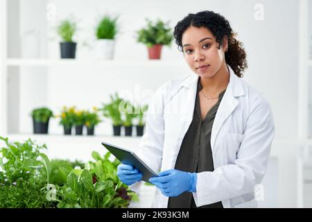 I enjoy studying and observing nature. a scientist using a digital tablet while standing in a lab. Stock Photo