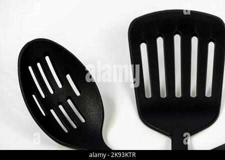 black plastic kitchen utensils isolated on white. Clipping path included. mexico Stock Photo