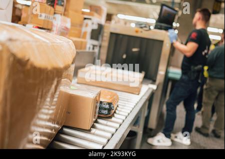 Cologne, Germany. 21st Oct, 2022. Packages lie on a conveyor belt to be checked with the help of an X-ray scanner. In search of drugs, customs inspects several hundred packages every night. Credit: Marius Becker/dpa/Alamy Live News Stock Photo