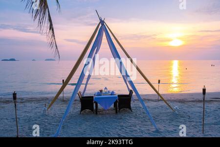 Romantic dinner on a beach in Koh Chang Thailand during sunset. Table with dinner on a beach  Stock Photo