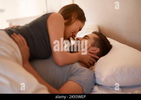 Heres that goodnight kiss youve been asking for. a loving young couple spending quality time together in their bedroom. Stock Photo