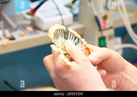 A palette for determining the color of teeth in the hands of a dental orthopedist. Stock Photo