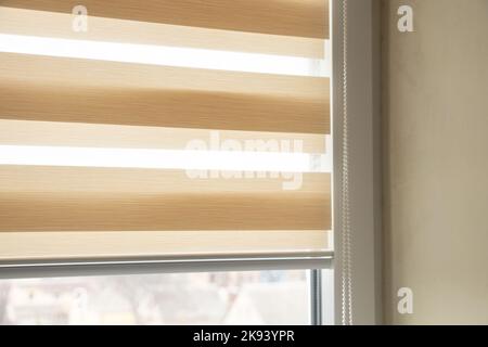 beige blinds day night on the kitchen window close up Stock Photo