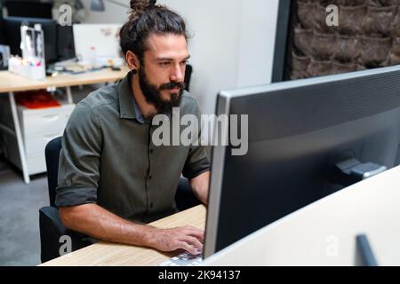 Tired exhausted man, office worker, manager or freelancer, working in office Stock Photo