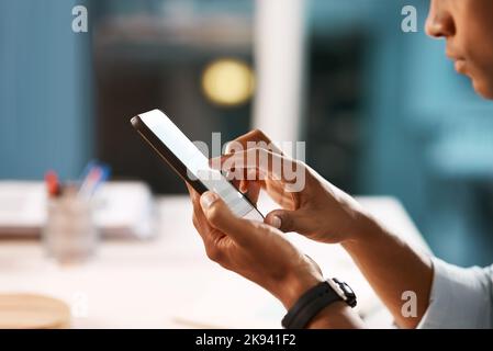 Hes adding a nice touch to his business dealings. an unrecognizable businessman using a digital tablet while working late in his office. Stock Photo
