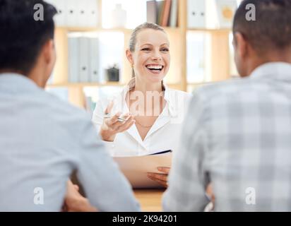 Planning, strategy and manager in a meeting, working and talking to employees about a report on company growth at work. Happy, smile and young boss in Stock Photo