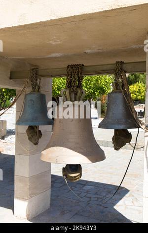 Bronce bells hangs in front of the Moni Thari monastery. The monastery is one of the most important religious monuments on the island of Rhodes. Stock Photo