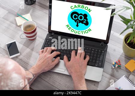 Carbon reduction concept shown on a laptop used by a man Stock Photo