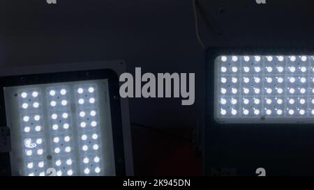 Several bright projectors in the dark room. LED diode lights. Stock Photo