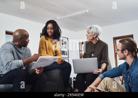Hes got everyones attention now. a group of businesspeople having a meeting and discussing ideas in their office at work. Stock Photo