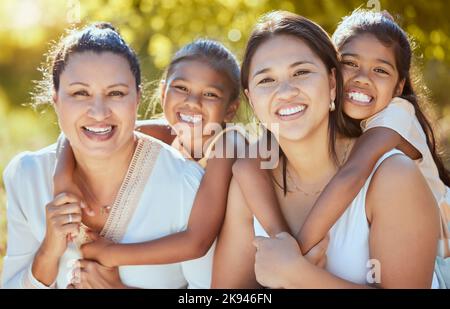 Family, portrait and women relax in a park, bonding with children, mother and grandmother in nature. Love, happy family and kids hug, smile and Stock Photo