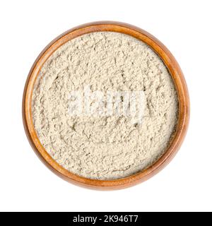 Bentonite, dry powder of montmorillonite in a wooden bowl. Used in folk medicine as medicinal clay. Absorbent swelling clay, weathered volcanic ash. Stock Photo