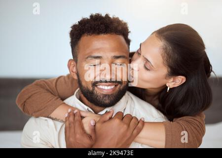 Love, black couple and kiss with hug, being happy and embrace together for marriage, anniversary and bonding. Romance, man and woman being loving Stock Photo