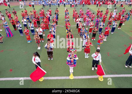 LIUZHOU, CHINA - OCTOBER 26, 2022 - Students play Hulusi, an ethnic musical instrument, during a track and field meeting at Rong 'an County Experiment Stock Photo