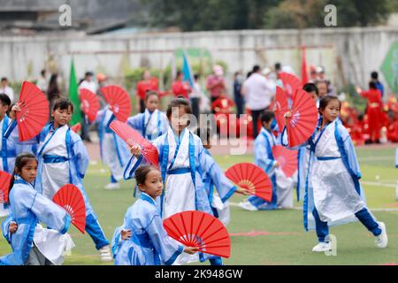 LIUZHOU, CHINA - OCTOBER 26, 2022 - Students dressed in Hanfu show fan dance during a track and field meet at Rong 'an County Experimental Primary Sch Stock Photo