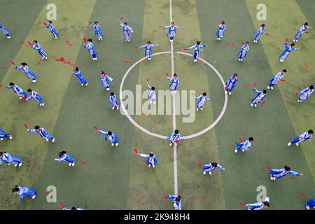 LIUZHOU, CHINA - OCTOBER 26, 2022 - Students dressed in Hanfu show fan dance during a track and field meet at Rong 'an County Experimental Primary Sch Stock Photo