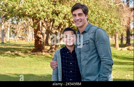 My dad, my best friend. a young boy spending quality time with his father at the park. Stock Photo