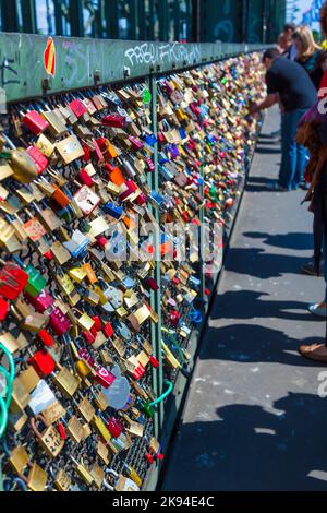 COLOGNE, GERMANY - MAY 11, 2011: people enjoy to walk along the promenade at the Hohenzollern bridge  in Cologne, Germany. It is the most heavily used