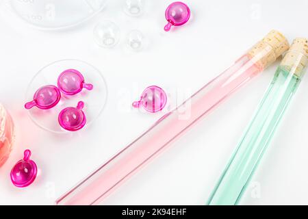 Serum capsules for healthy skin. Skin care and supplements for clear and radiant skin. Equipment and science experiments in the laboratory. Stock Photo