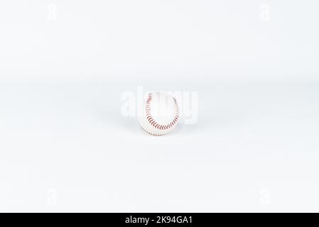 Baseball ball on white background isolated. Baseball ball with red stitch. Clipping path isolated. United states of america soccer or football sport. Stock Photo