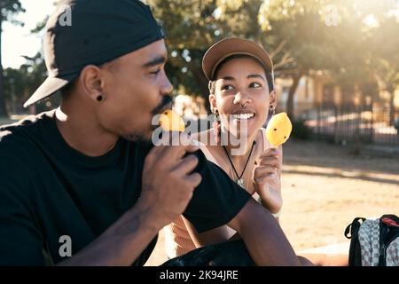 Ice cream, sweet and couple in city with food during travel, adventure and holiday in street. Happy, young and relax man and woman eating ice dessert Stock Photo