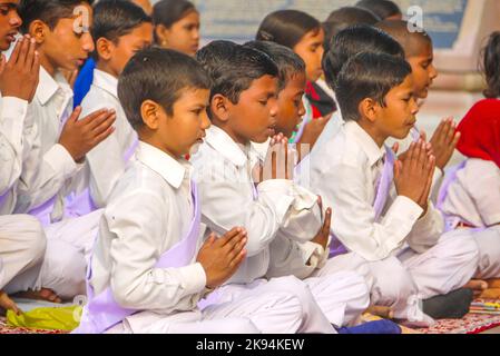 VARANASI, INDIA - 11 DECEMBER: young children pray in tibetan buddhist monastery Sarnath in holy Varanasi, Uttar Pradesh, on December 11, 2011 in Vara Stock Photo