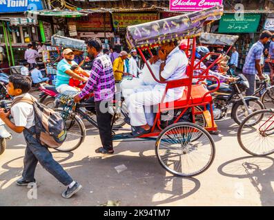 DELHI, INDIA - OCT 10: Rickshaw rider transports passenger on October ...