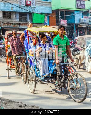 DELHI, INDIA - OCT 10: Rickshaw rider transports passenger on October ...