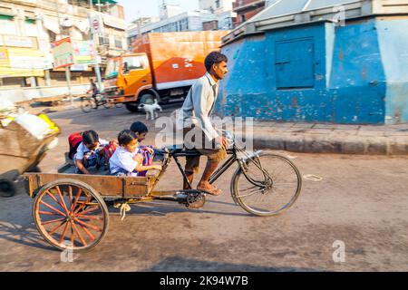 DELHI, INDIA - OCT 16: father transports his children on october 16, 2012 in Delhi, India. Cycle rickshaws were introduced in to Delhi in the 1940's b Stock Photo