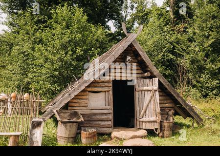 Triangular log houses with wooden roofs in an old medieval village Stock Photo