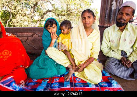 DELHI, INDIA - OCTOBER 16: A family of worshipers rest on the courtyard of Jama Masjid Mosque on October 16, 2012 in Delhi, India. Jama Masjid is the Stock Photo