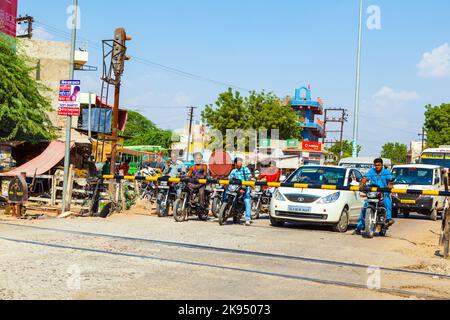 JAIPUR, INDIA - OCTOBER 23: Indian Railway train passes a railroad crossing on October 23, 2012 in Jaipur, India. Indian Railways is one of the world' Stock Photo