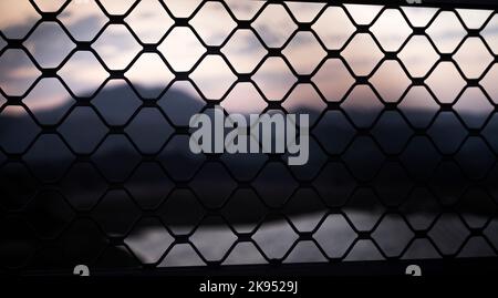 Metal Grill pattern from the Dam with mountain background Stock Photo