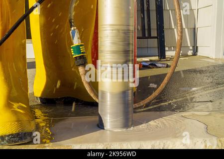 In construction site an industrial drilling machine is used to drill hole into concrete Stock Photo