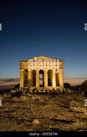 Italy, Sicily, Agrigento. Valle Dei Templi. Greek Temple of Concordia 440 bc. Floodlit at night as the sun sets behind. Stock Photo