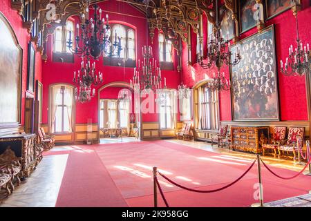 A room with furniture and portraits inside Miramare Castle near Trieste, Italy Stock Photo