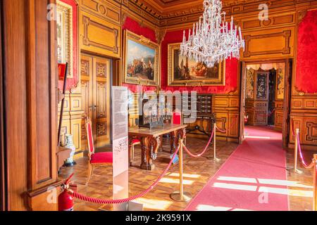 A room with furniture and portraits inside Miramare Castle near Trieste, Italy Stock Photo