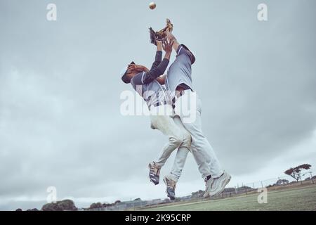 Sports, action and a men catch baseball, jump in air with ball in baseball glove. Energy, sport and catch, baseball player on the field or pitch Stock Photo