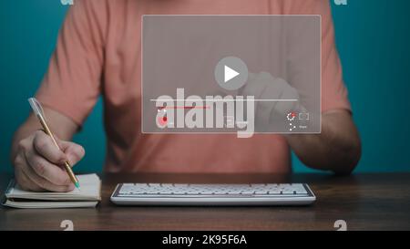 E learning concept. Casual business man using computer learning, studying online course and writing on notebook. Stock Photo