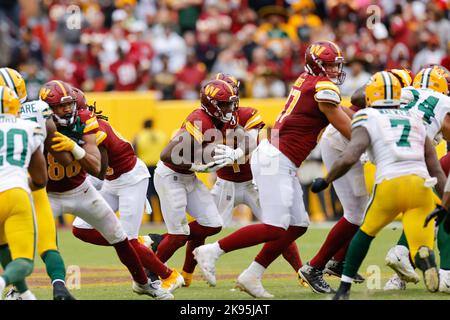 Sunday, October 23, 2022; Landover, MD, USA;  Washington Commanders quarterback Taylor Heinicke (4) hands off the ball during an NFL game against the Stock Photo