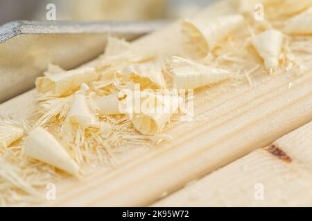 Carpenter drilling holes in the wood beam. wooden frame domestic house building Stock Photo