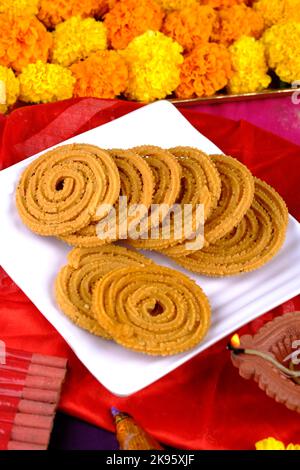 Traditional Indian Diwali snacks Chakali, murukku, Indian Traditional Tea Time Snack Chakli, Muruku, Murkoo, Chakri, which is prepared during Diwali. Stock Photo