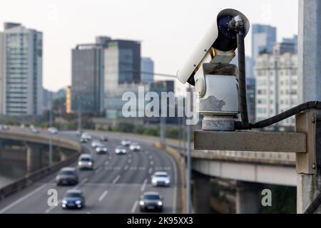 Security camera on the bridge watching after the car traffic, and speed control. Closeup of traffic security camera surveillance (CCTV) on the road in Stock Photo