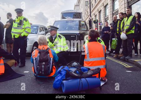 London, England, UK. 26th Oct, 2022. Just Stop Oil activists glued their hands and blocked Piccadilly outside The Ritz hotel, as they continue their protests demanding the government stops issuing new fossil fuel licences. (Credit Image: © Vuk Valcic/ZUMA Press Wire) Stock Photo