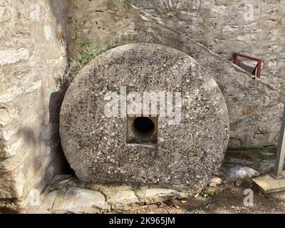 An old olive grinding stone with a hole in the center Stock Photo
