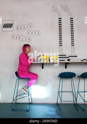 Gemma Sherlock plays with LEGO as she stops for a coffee at the opening of the world’s first experimental LEGO® Brick Cafe in Dublin city centre, an inspiration space giving adults the opportunity to experience and play with LEGO bricks. Picture date: Wednesday October 26, 2022. Stock Photo