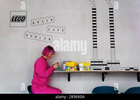 Gemma Sherlock plays with LEGO as she stops for a coffee at the opening of the world’s first experimental LEGO® Brick Cafe in Dublin city centre, an inspiration space giving adults the opportunity to experience and play with LEGO bricks. Picture date: Wednesday October 26, 2022. Stock Photo