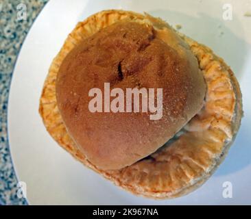 Wigan Lancashire Pie Burger, a steak or Meat pie on a oven bottom muffin Stock Photo