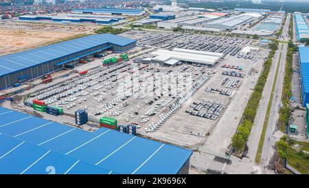 Klang, Malaysia-October 9, 2022: Automobile and car parking lot for commercial business industry. Aerial view new car lined up in port for import and Stock Photo